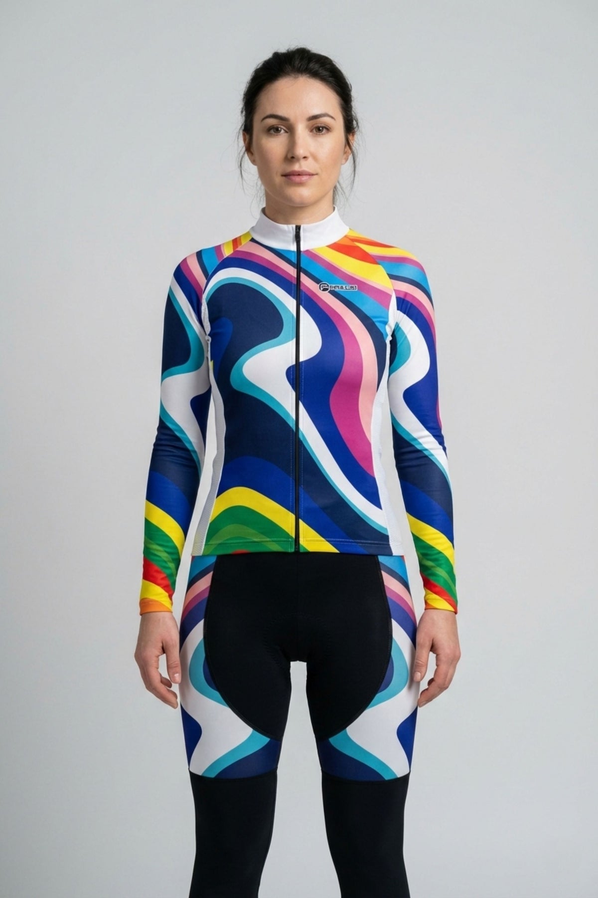 Person wearing a rainbow cycling set accents by Cycling Frelsi on a gray background