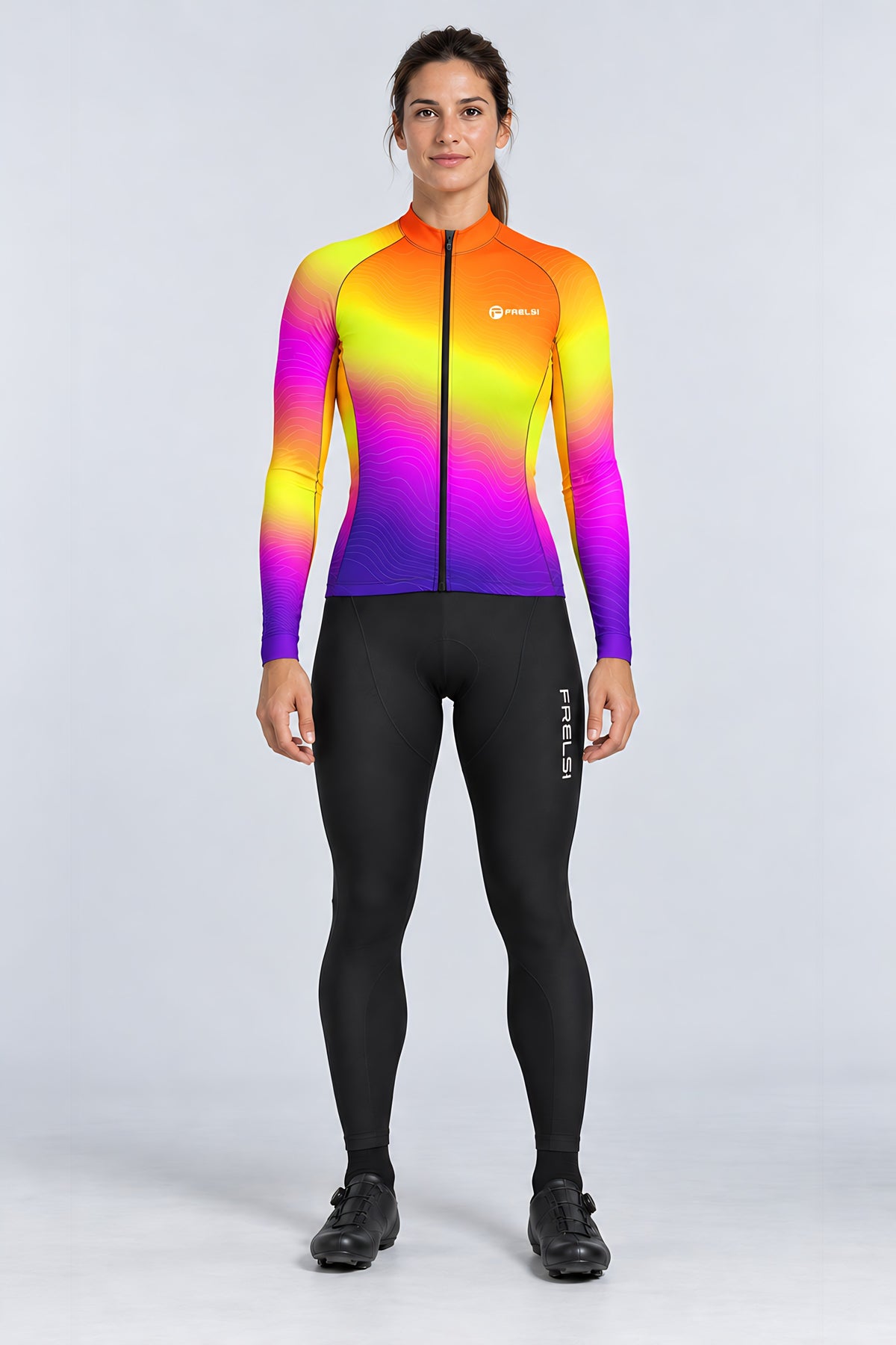 Woman wearing the Sunset Pulse long sleeve cycling jersey with black bib tights - front view