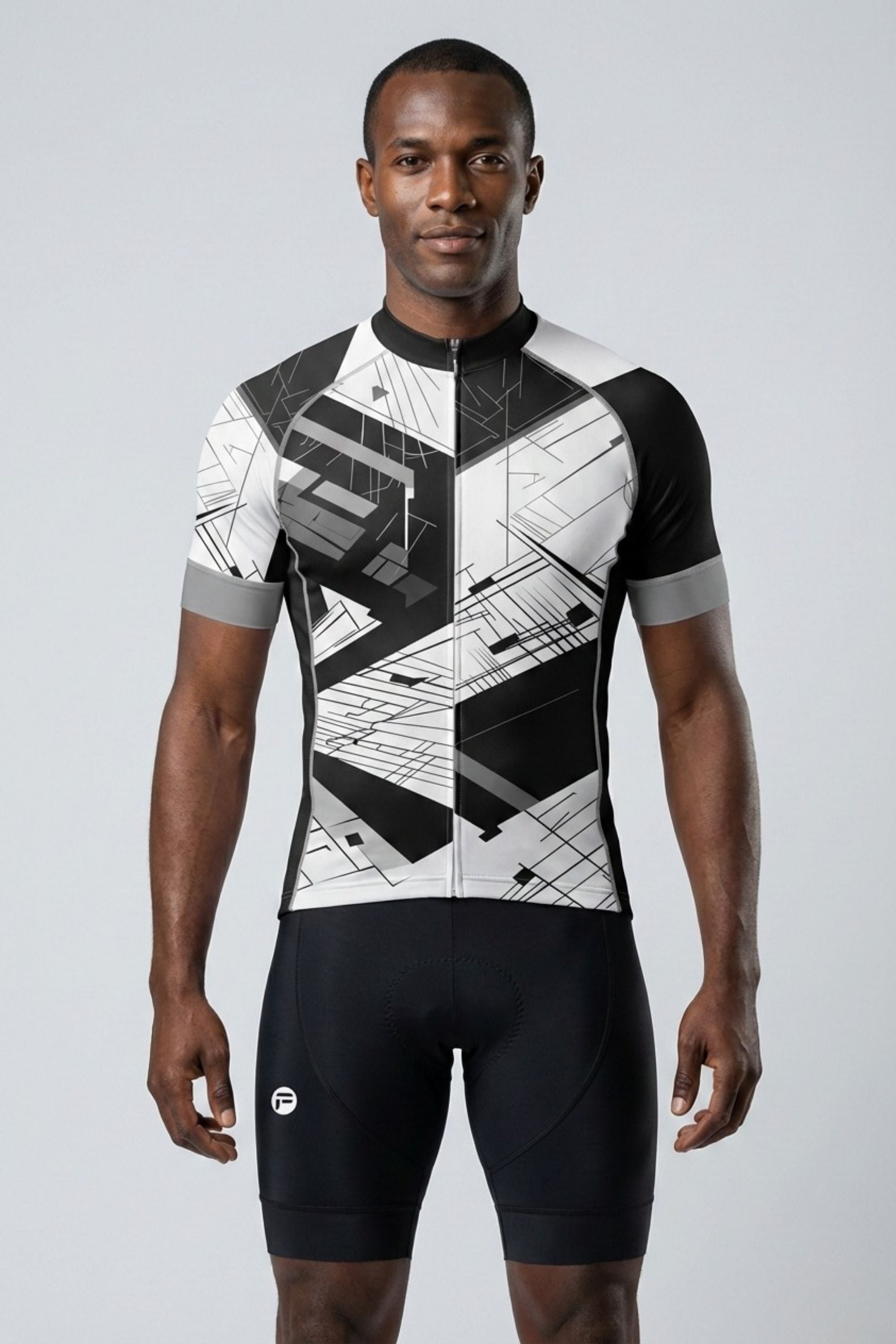 Man wearing a black and white cycling outfit on a gray background