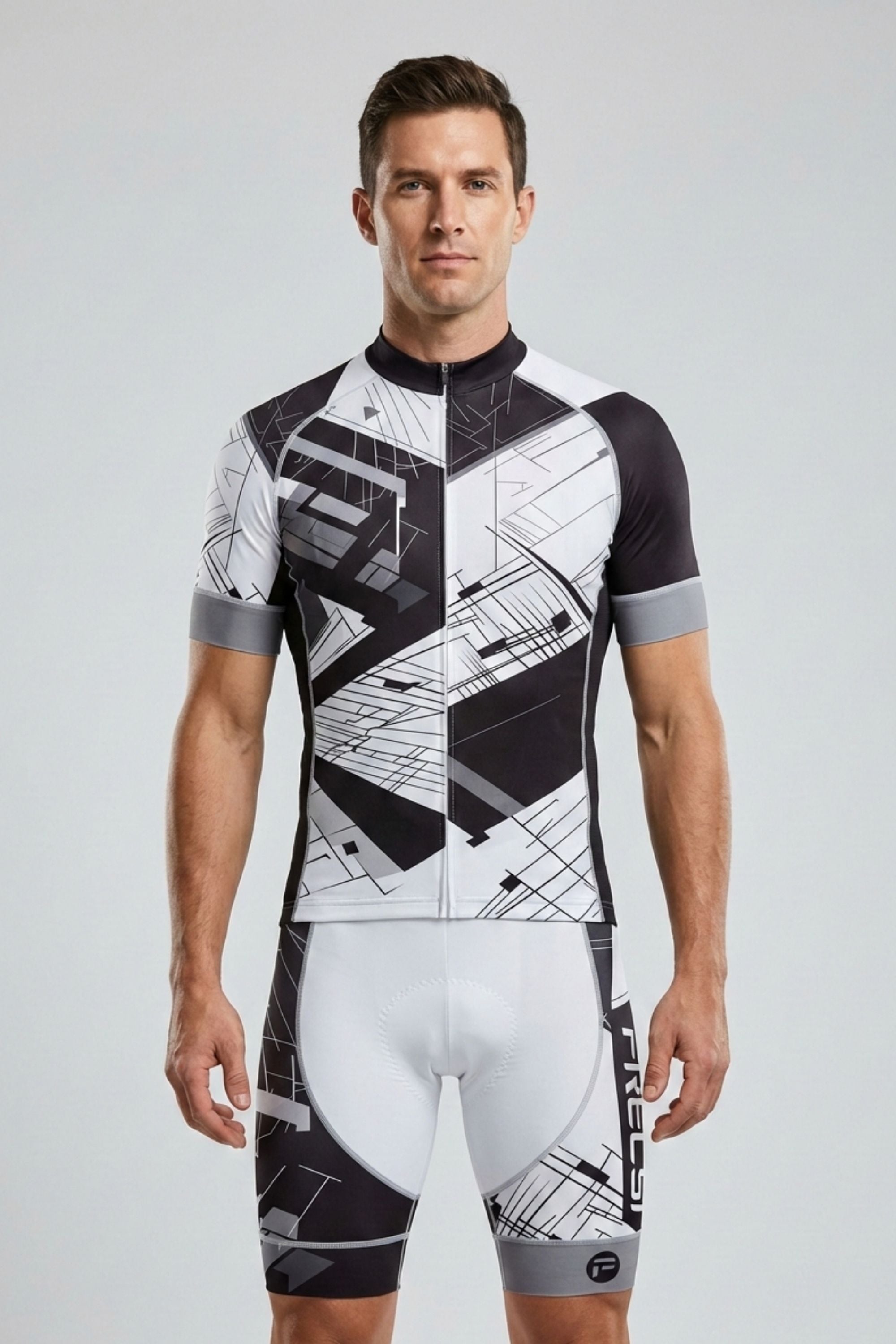 Man wearing a black and white geometric cycling outfit on a light gray background