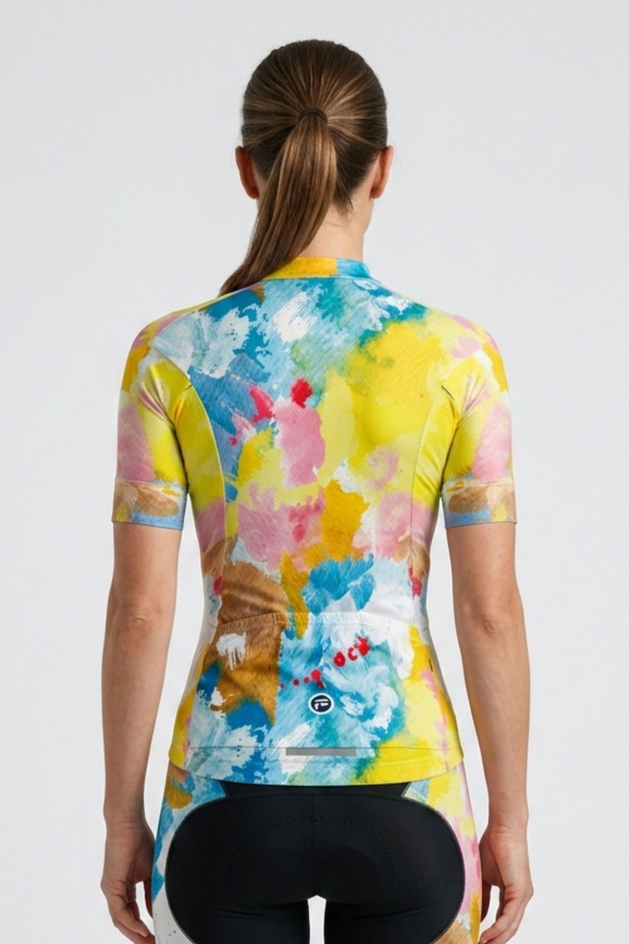 Woman wearing a colorful cycling jersey with abstract design on a white background