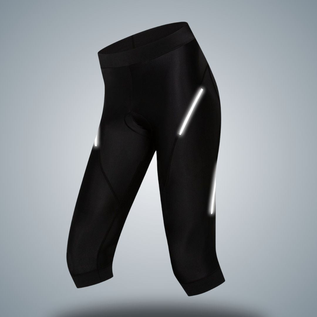 Women's 3/4 cycling tights in sleek black with reflective accents for enhanced visibility during low-light rides. Designed for comfort and performance, these tights feature a form-fitting design with a supportive waistband and ergonomic stitching, ideal for mid-season cycling.