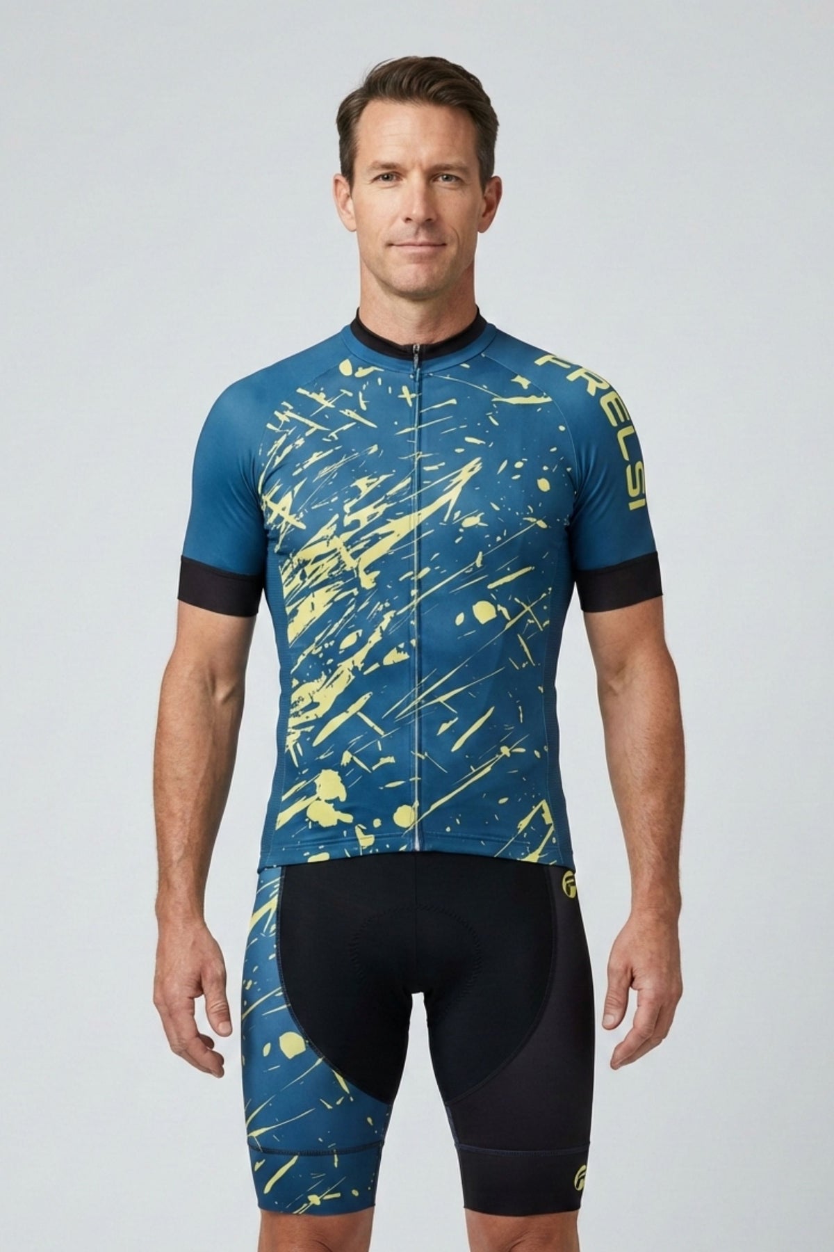 Man wearing a blue and yellow cycling jersey with black shorts on a light gray background